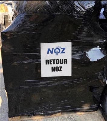 a sign that says noz retour noz on the back of a truck