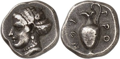 a close up of a coin with a skull on it