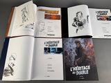 several books are open on a table with drawings of characters