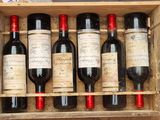 six bottles of wine in a wooden box