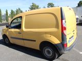 a small yellow van parked in a parking lot