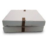 two white boxes with brown stripes on them on a white surface