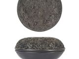 a black plate with a silver lid on a white surface