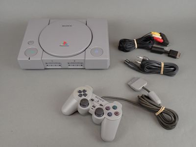a video game console and a game controller on a table