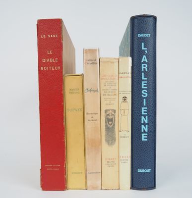 several books are stacked on top of each other on a white surface