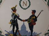 a plate with a picture of two men shaking hands