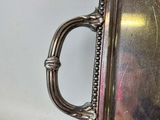 a silver tray with a handle on it on a table