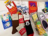 several pairs of socks are sitting on a table next to a package of socks