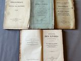 several old books sitting on top of a table next to each other