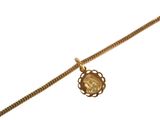 an image of a gold necklace with a coin on a chain