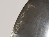 a close up of a silver spoon with writing on it
