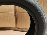 a close up of a tire on a cardboard box with a cardboard box in the background
