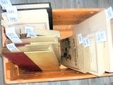 many books in a box with price tags on them