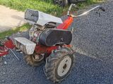 a small tractor that is parked on the side of the road