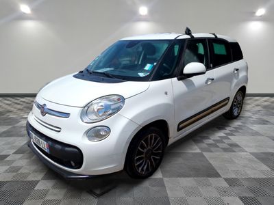 a picture of a small white car parked in a garage