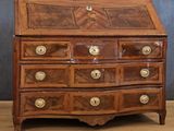 a small wooden desk with drawers on top of it