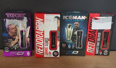 five different action figures in the box on the table