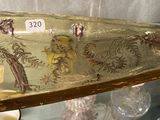 a glass boat shaped like a boat with a dragon on it