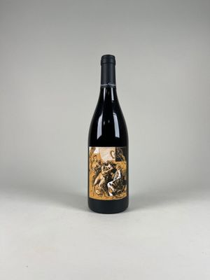 a bottle of wine sitting on top of a white table