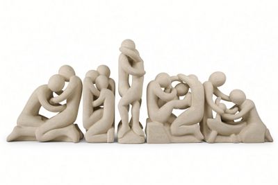 a sculpture of a group of people sitting on a white surface