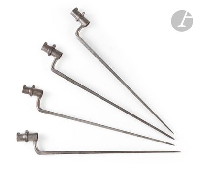 a set of four metal screws on a white background
