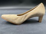 a close up of a pair of beige shoes on a gray surface