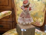 a doll sitting on top of a chair in a room