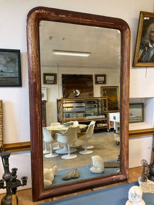 un grand miroir posé sur une table dans une pièce