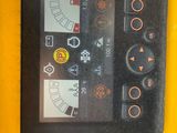 a close up of a control panel on a yellow machine