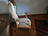 a chair that is sitting in a room with a rug on the floor