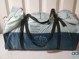 a blue and white duffel bag sitting on a table
