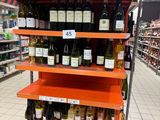 many bottles of wine on the shelves in the store
