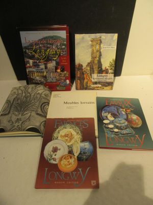 several books are sitting on a table in front of a black case