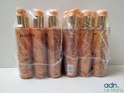 several bottles of makeup products wrapped in plastic bags on a table