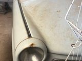 an old car that is parked in a garage