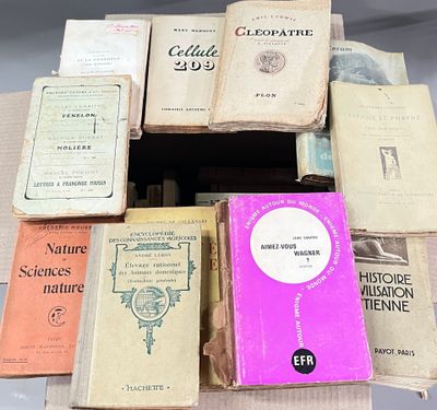 many books stacked on top of each other on a table