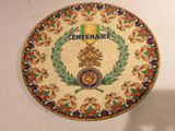 a decorative plate with the emblem of the centenaire on it