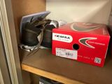 a box that is sitting on a shelf next to a pair of shoes