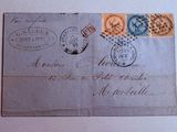 an old postcard with stamps on it sitting on top of a table