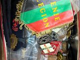 a suitcase filled with assorted items that include hats, scarves, and other items