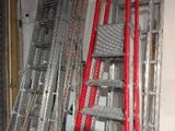 many ladders that are stacked up in a room