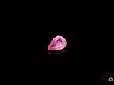 a pink diamond on a black background