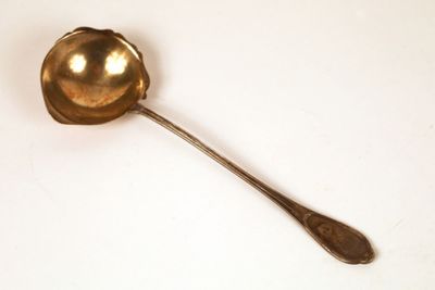 a spoon that is sitting on a white surface