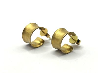 a pair of gold earrings on a white background