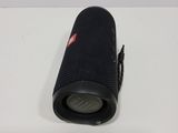 a close up of a black speaker on a white surface