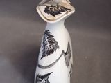 a white vase with a black and white design on it