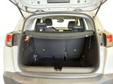 the back of a car with its trunk open and the back seats folded down
