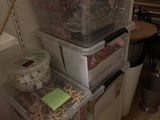 a stack of plastic containers sitting on top of a refrigerator