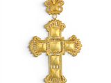 a gold cross with a crown on top of it