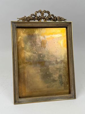 an old picture frame with a gold leaf decoration on it